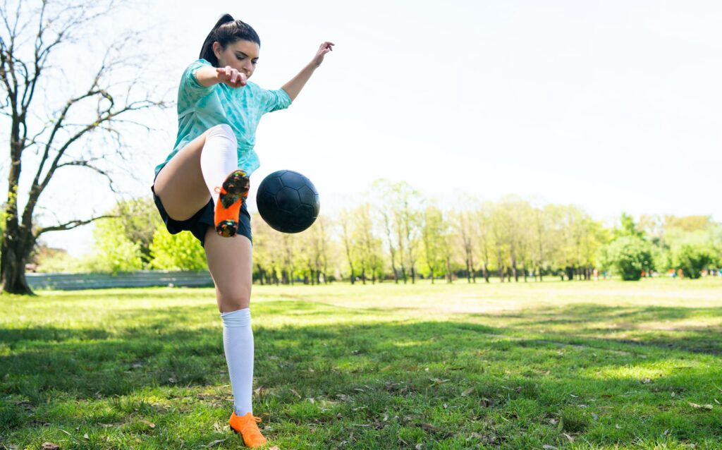 Young woman practicing soccer skills with ball.