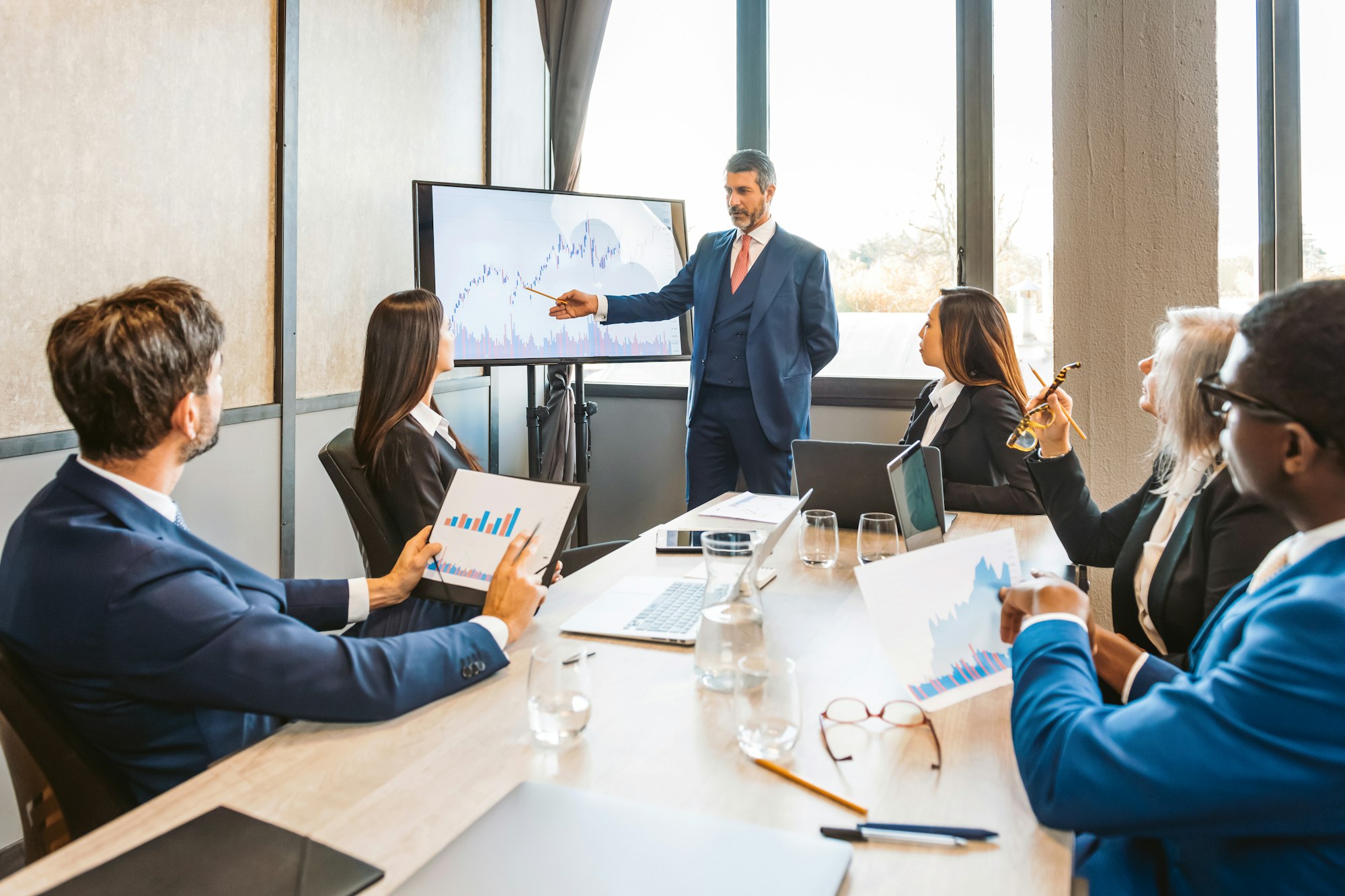 Boss showing graphs to employees