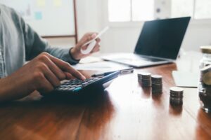 Closeup accountant using calculator.